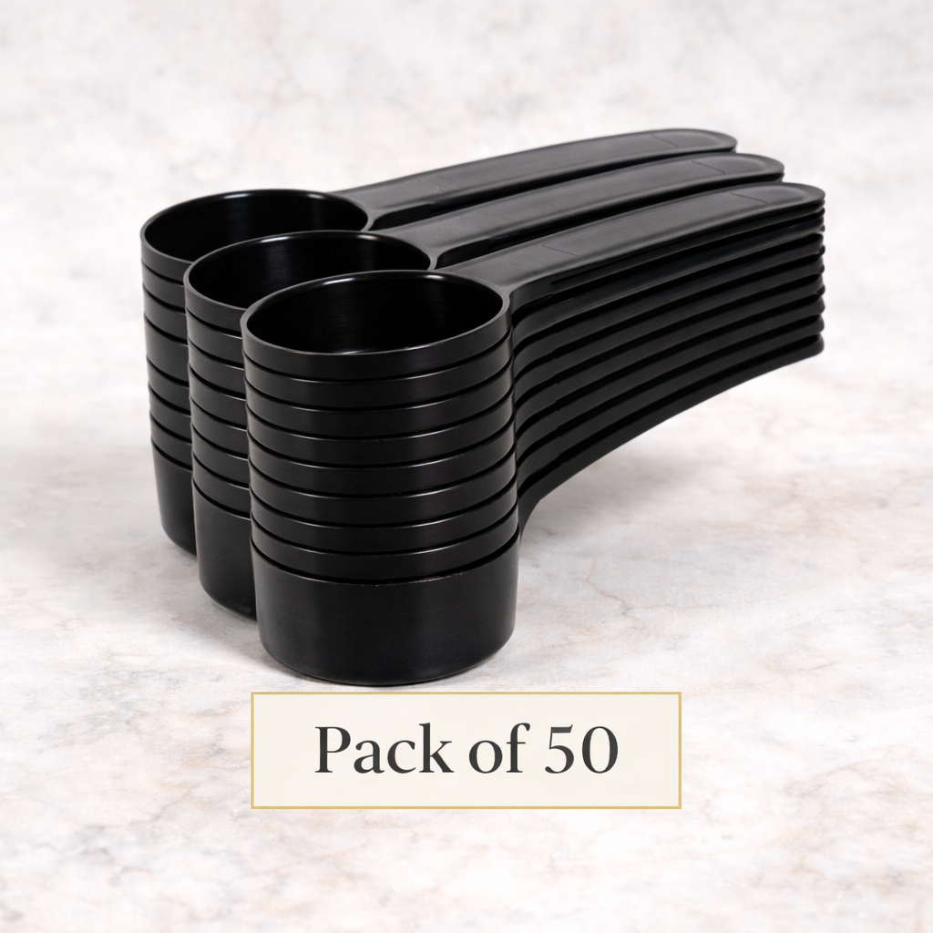 Pack of 50 black measuring spoons on a light gray background