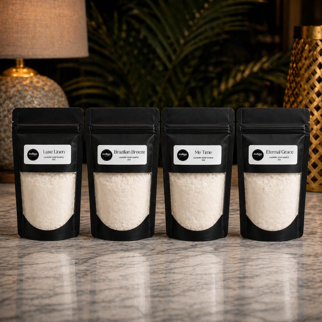 Four black ziplock bags with luxe laundry powder on a marble surface with a blurred background