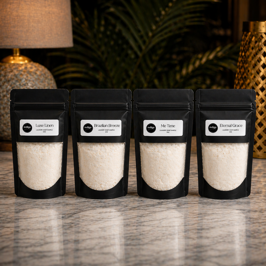 Four black ziplock bags with luxe laundry powder on a marble surface with a blurred background
