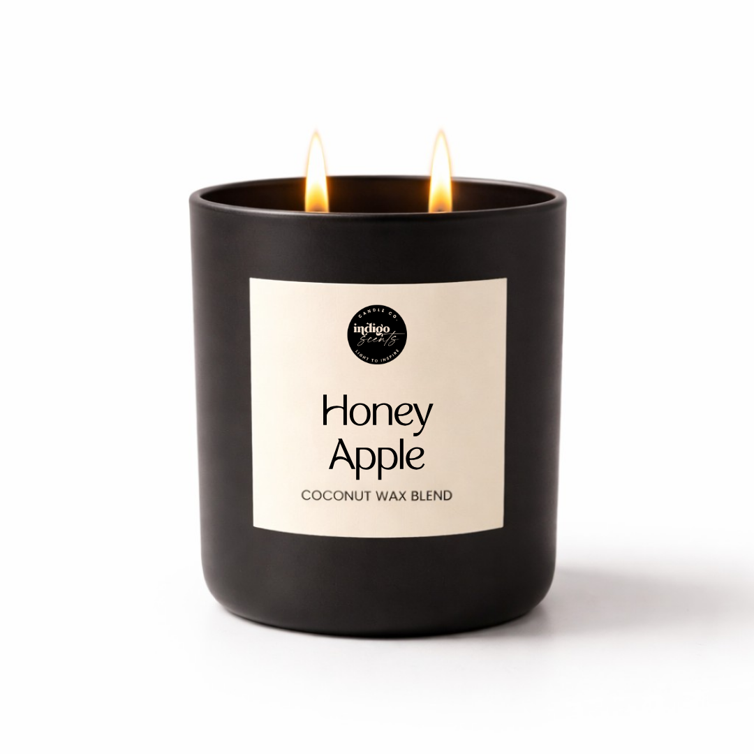 Honey Apple candle in a matte black jar on a white background, featuring a warm fruity fragrance with apple, honey butter, vanilla sugar, and soft musk