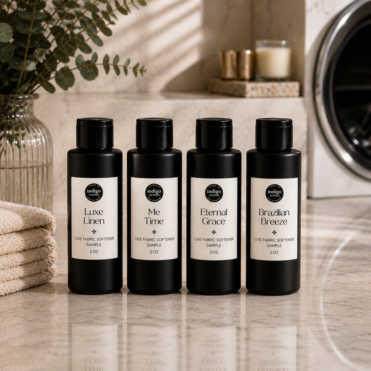 Four black bottles of fabric softener with labels on a bathroom counter.