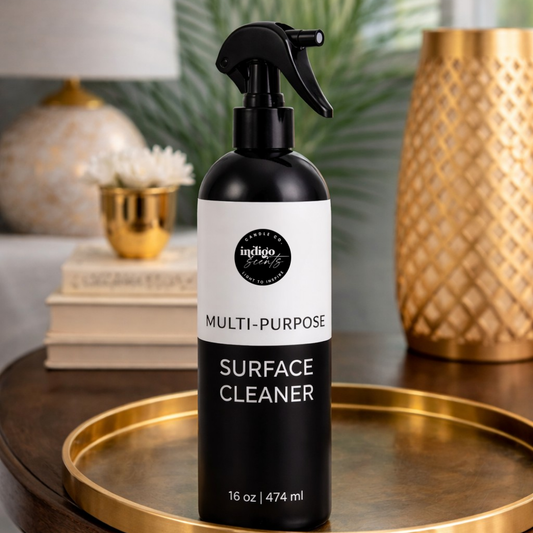Black and white multi-purpose surface cleaner bottle on a wooden table with decorative items in the background.