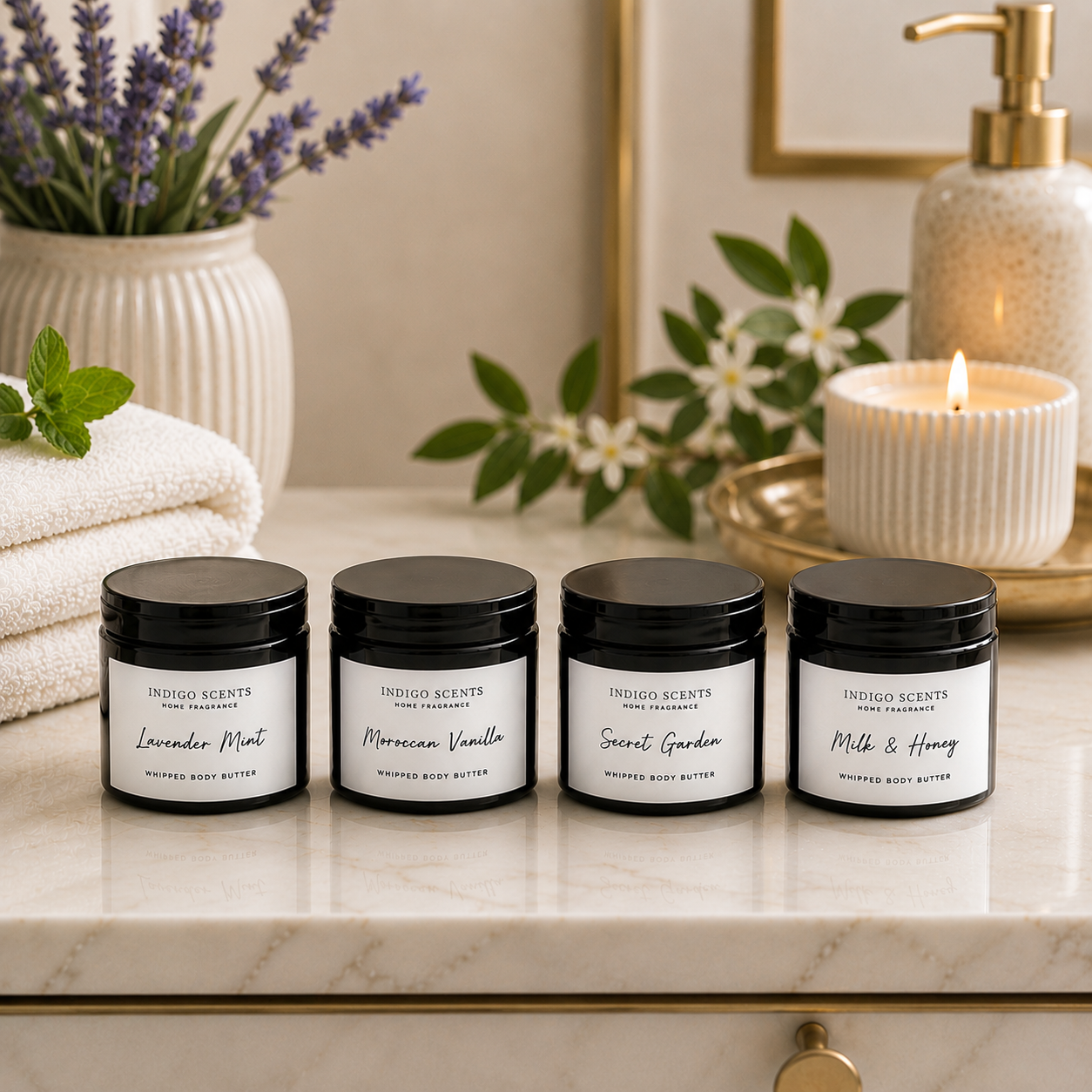 Four jars of Indigo Scents body butter on a marble surface with decorative elements.